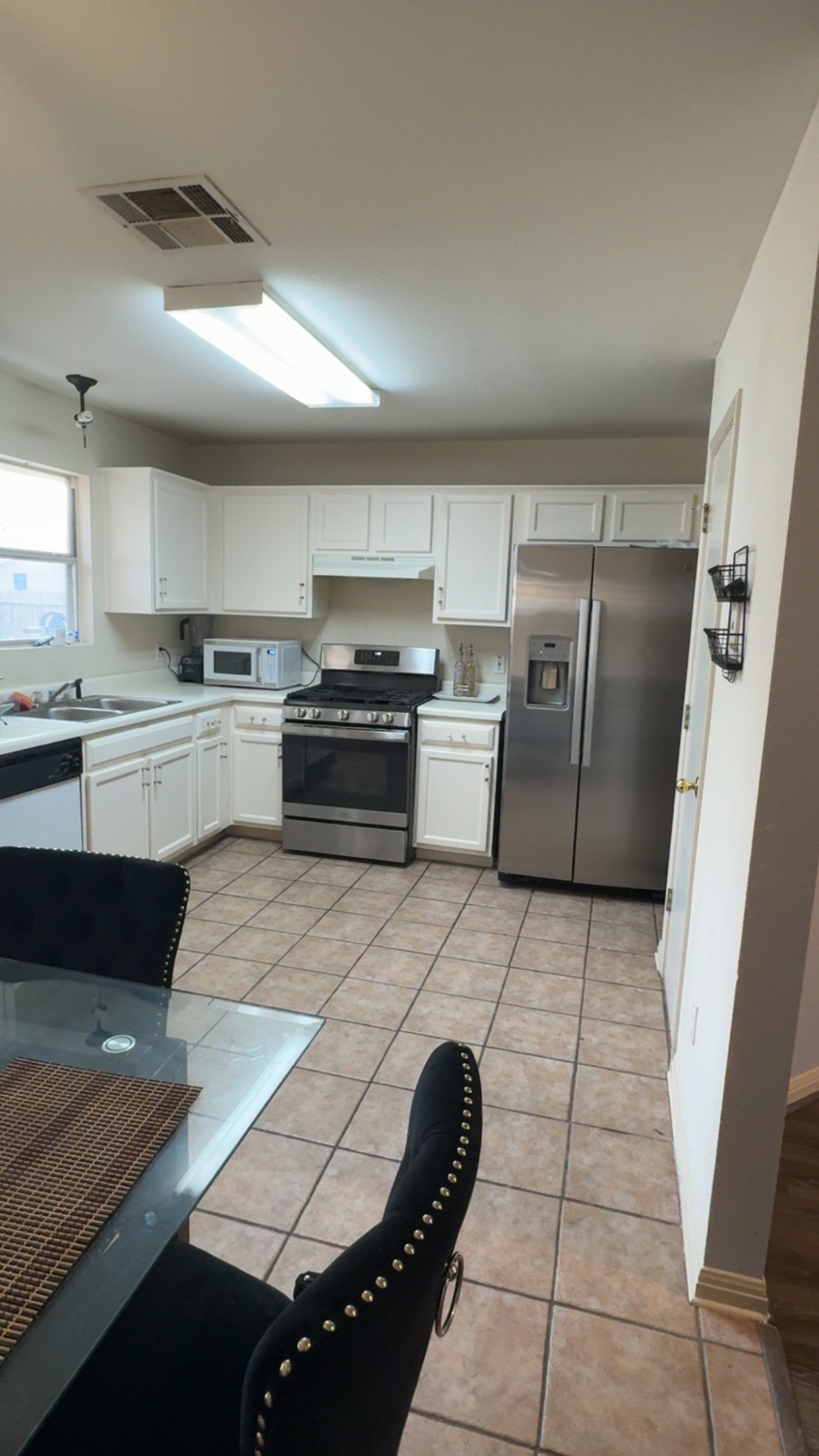 310 Raintree Drive Georgetown, TX 78626 - Photo 5 of 8 a large kitchen with granite countertop a stove a sink dishwasher and a refrigerator