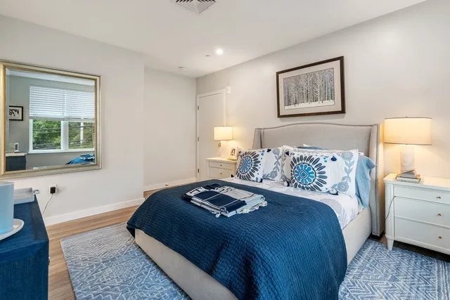 a bedroom with a bed and a lamp