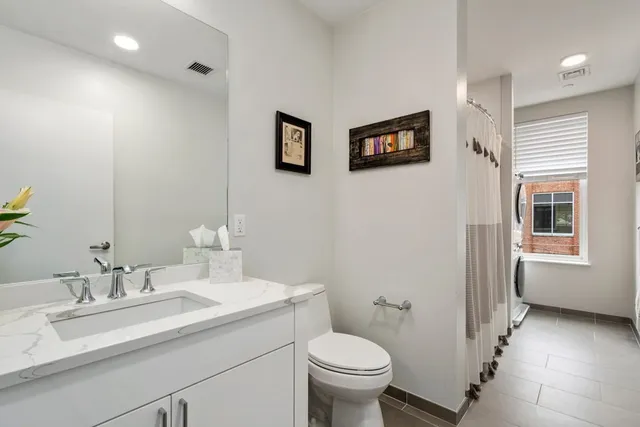 a bathroom with a sink toilet and a mirror