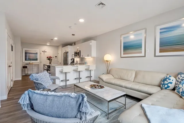 a living room with furniture kitchen and a table