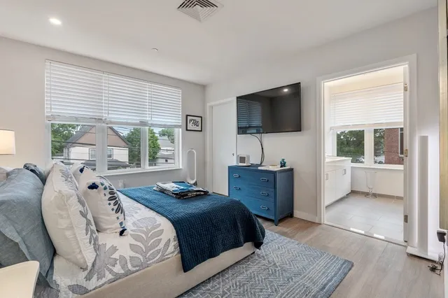 a bedroom with a large bed and a flat screen tv