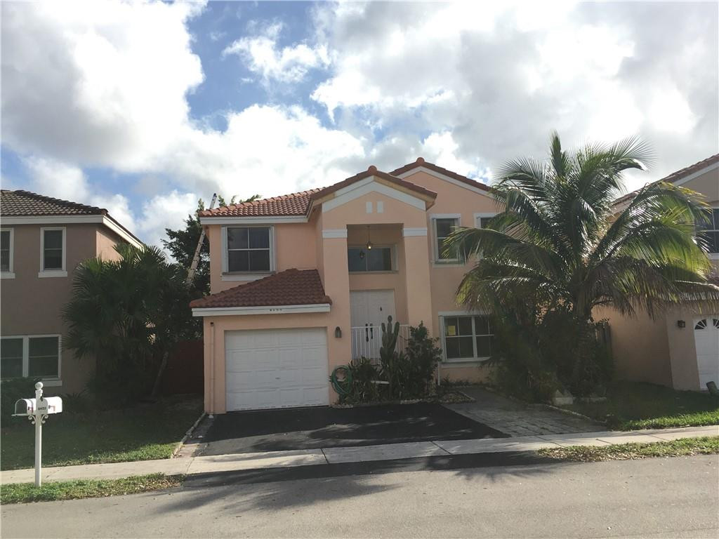 8422 Southwest 44th Place Davie, FL 33328 - Photo 1 of 16 a front view of a house with a yard and garage