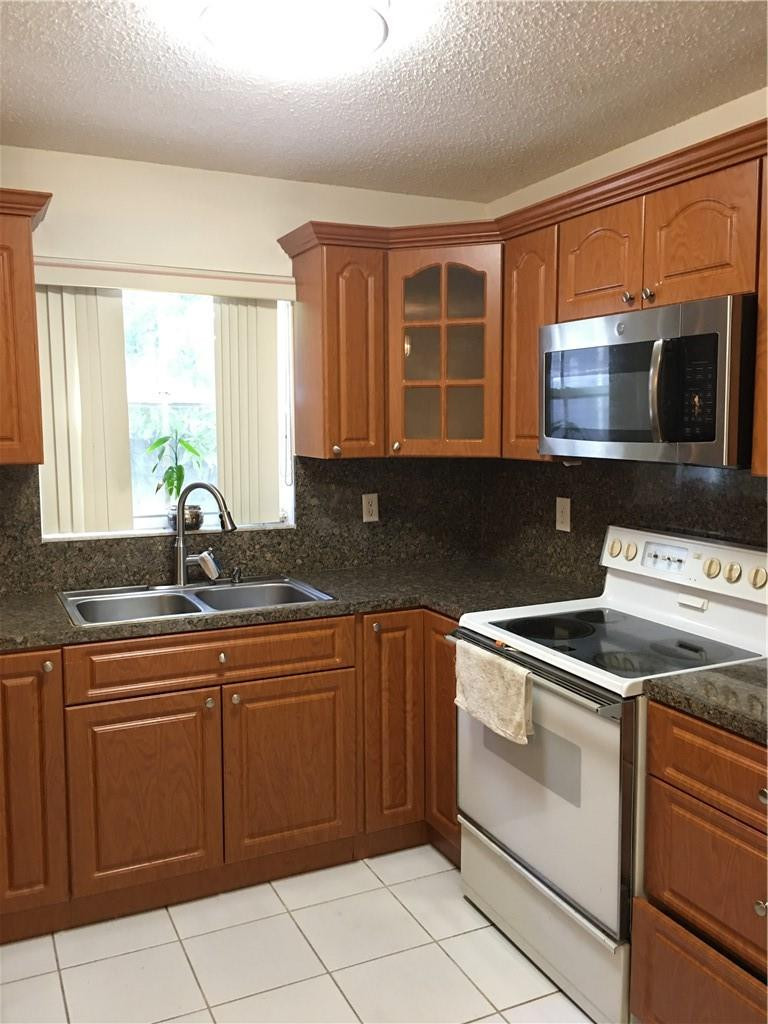 8422 Southwest 44th Place Davie, FL 33328 - Photo 4 of 16 a kitchen with a sink and cabinets