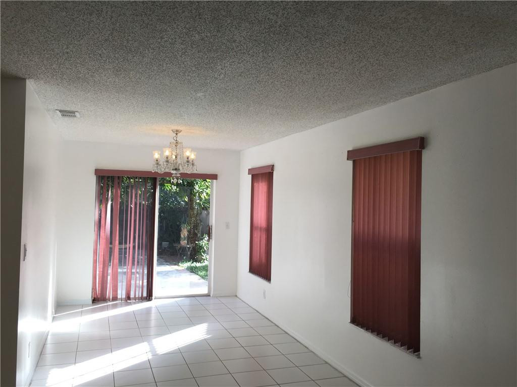 8422 Southwest 44th Place Davie, FL 33328 - Photo 6 of 16 a view of a room that has a bed and a chandelier