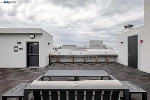a living room with kitchen island a table and chairs