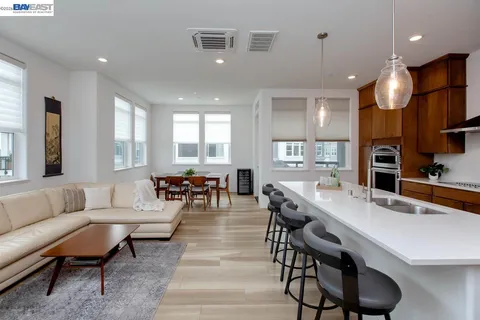 a living room with furniture kitchen and a table