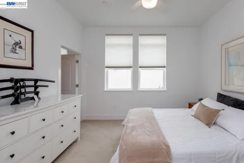 a bedroom with a large bed and a chandelier