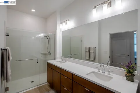 a bathroom with a double vanity sink and a mirror