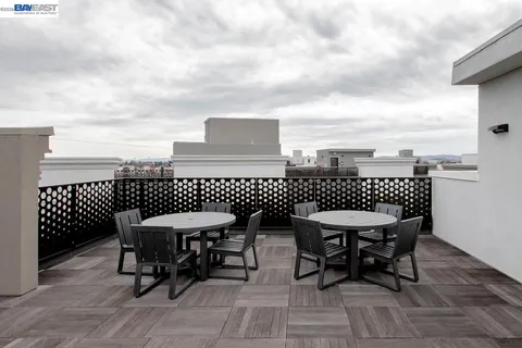 a balcony with table and chairs