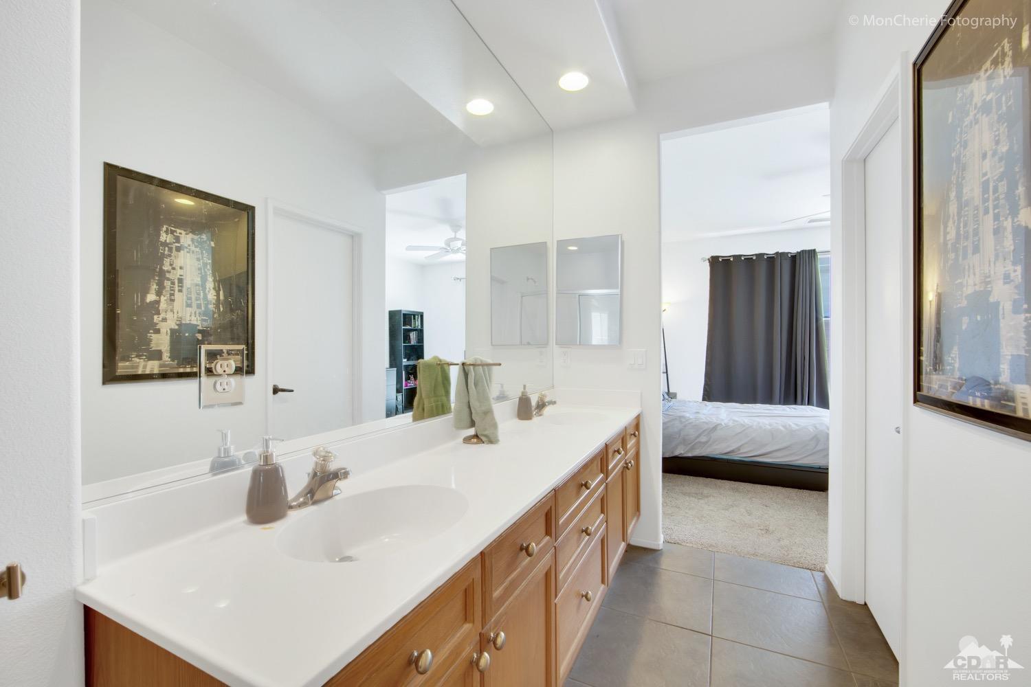 82903 Corte Lucia Indio, CA 92201 - Photo 16 of 26 a en suite bathroom with a double vanity sink and a mirror