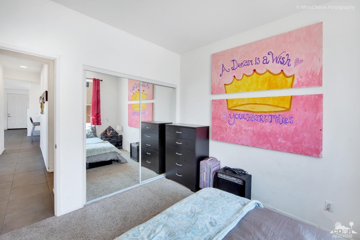 82903 Corte Lucia Indio, CA 92201 - Photo 18 of 26 a bedroom with a bed and wooden floor