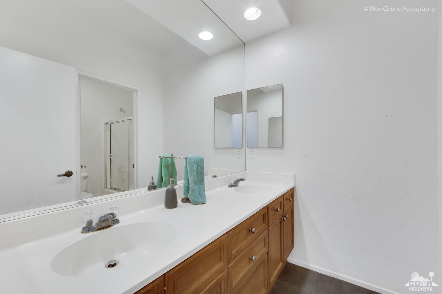 82903 Corte Lucia Indio, CA 92201 - Photo 19 of 26 a bathroom with double vanity sink and mirror