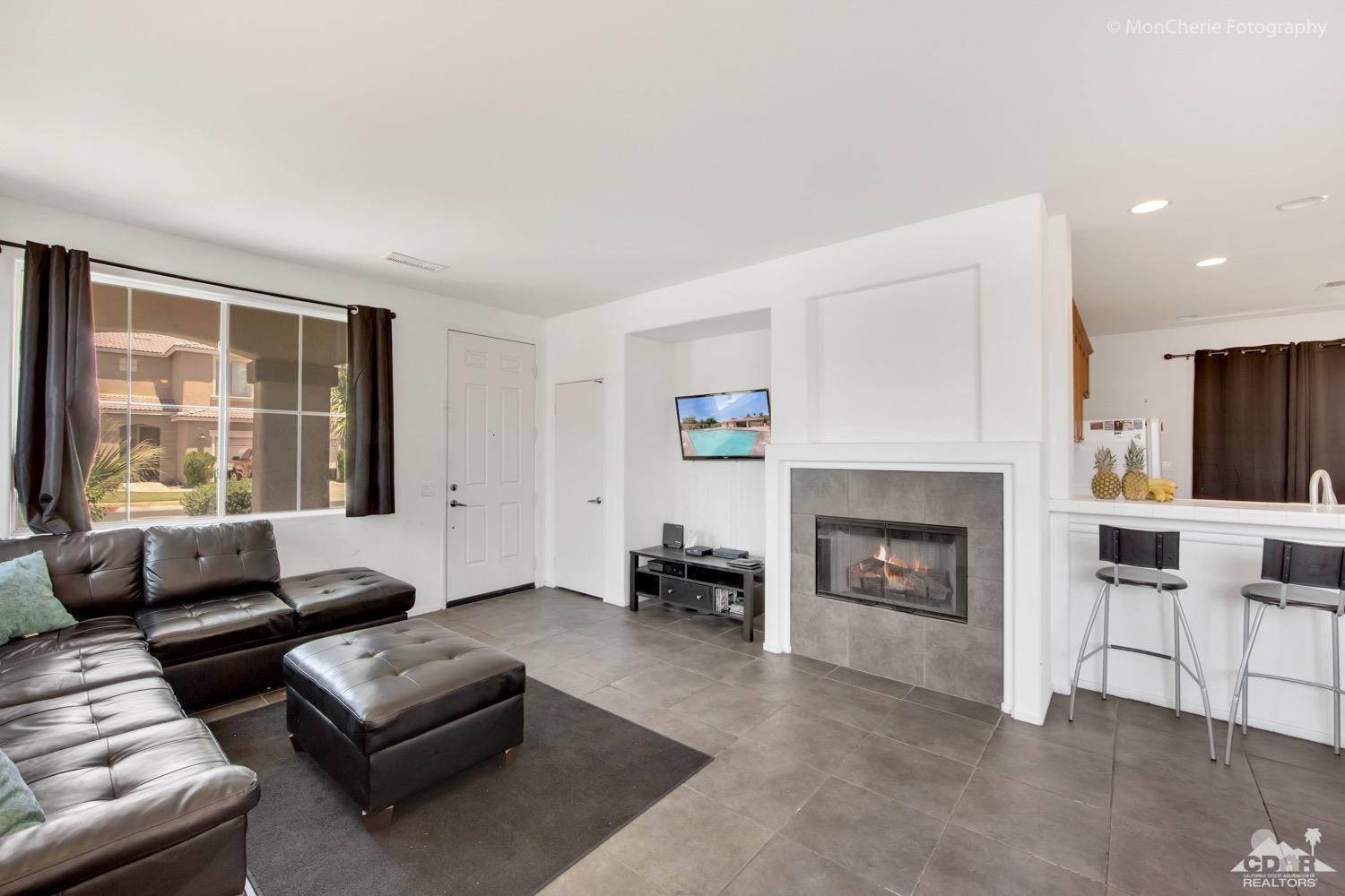 82903 Corte Lucia Indio, CA 92201 - Photo 3 of 26 a living room with furniture and a fireplace