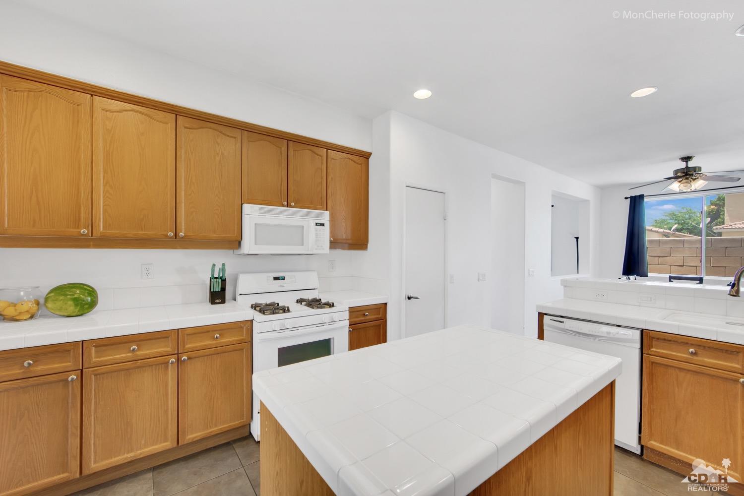 82903 Corte Lucia Indio, CA 92201 - Photo 8 of 26 a kitchen with a stove a sink a refrigerator and cabinets