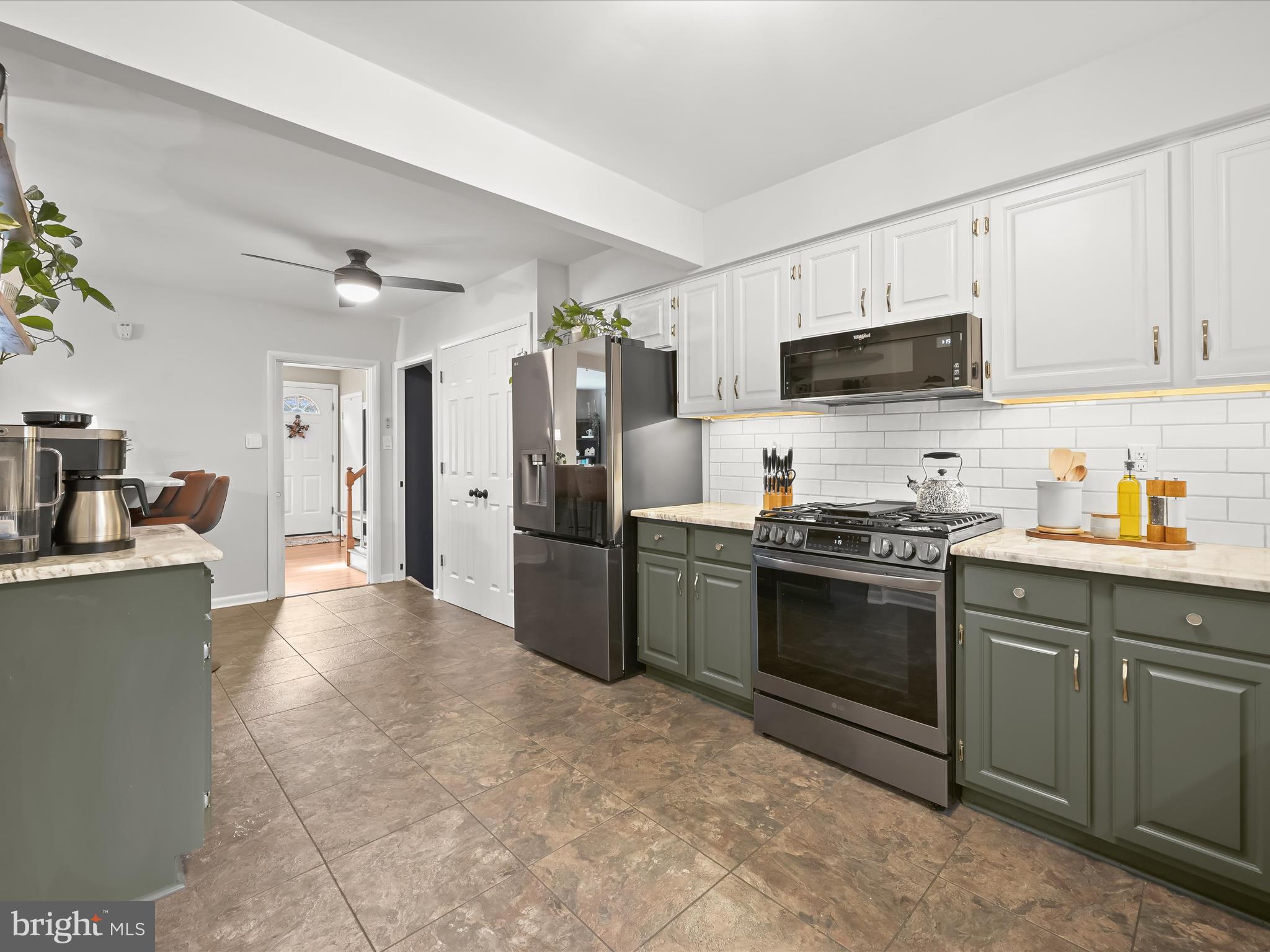 1910 Rollingwood Road Catonsville, MD 21228 - Photo 13 of 40 a kitchen with stainless steel appliances granite countertop a stove refrigerator sink and microwave