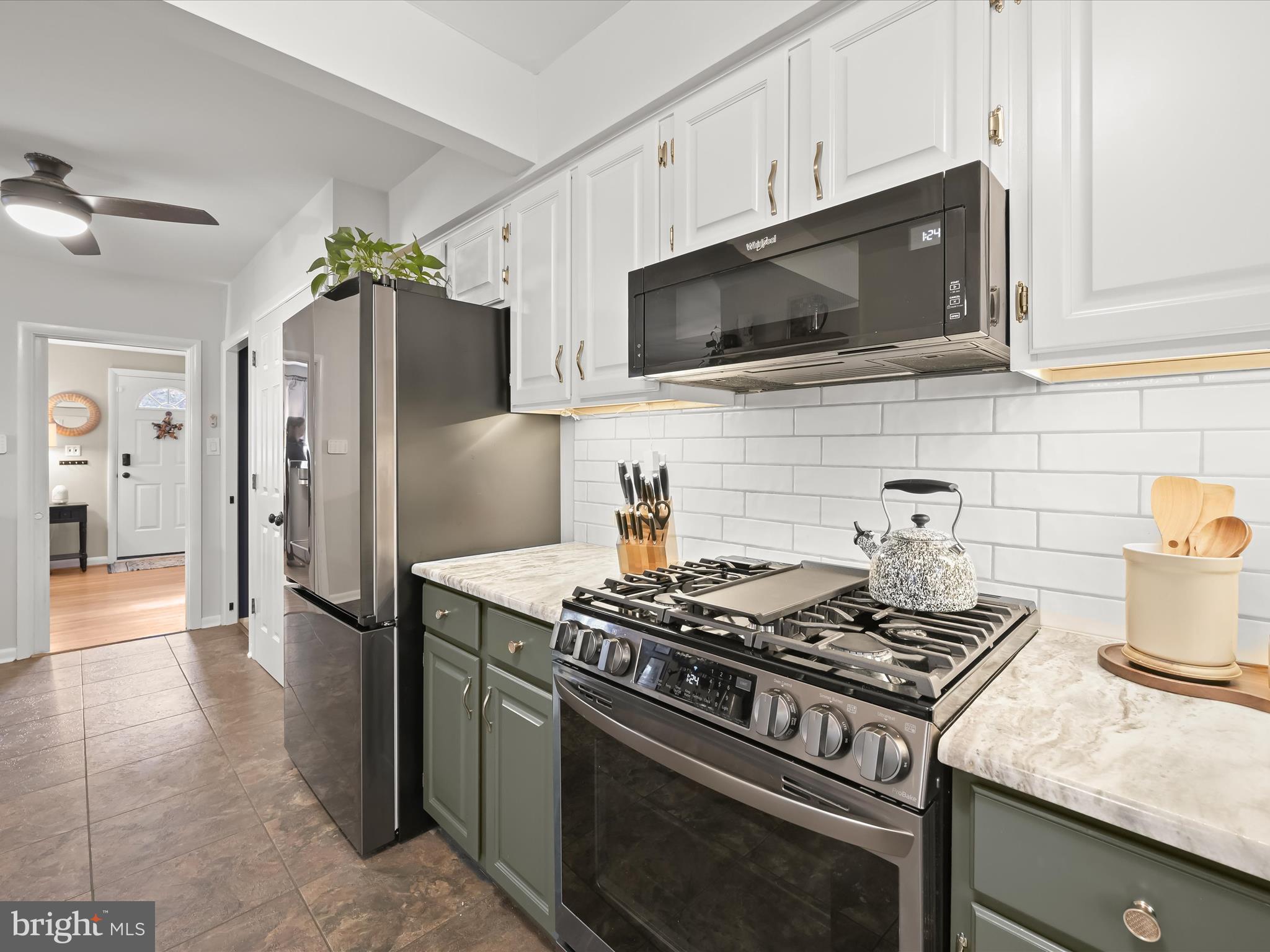 1910 Rollingwood Road Catonsville, MD 21228 - Photo 14 of 40 a kitchen with stainless steel appliances granite countertop a stove and a microwave
