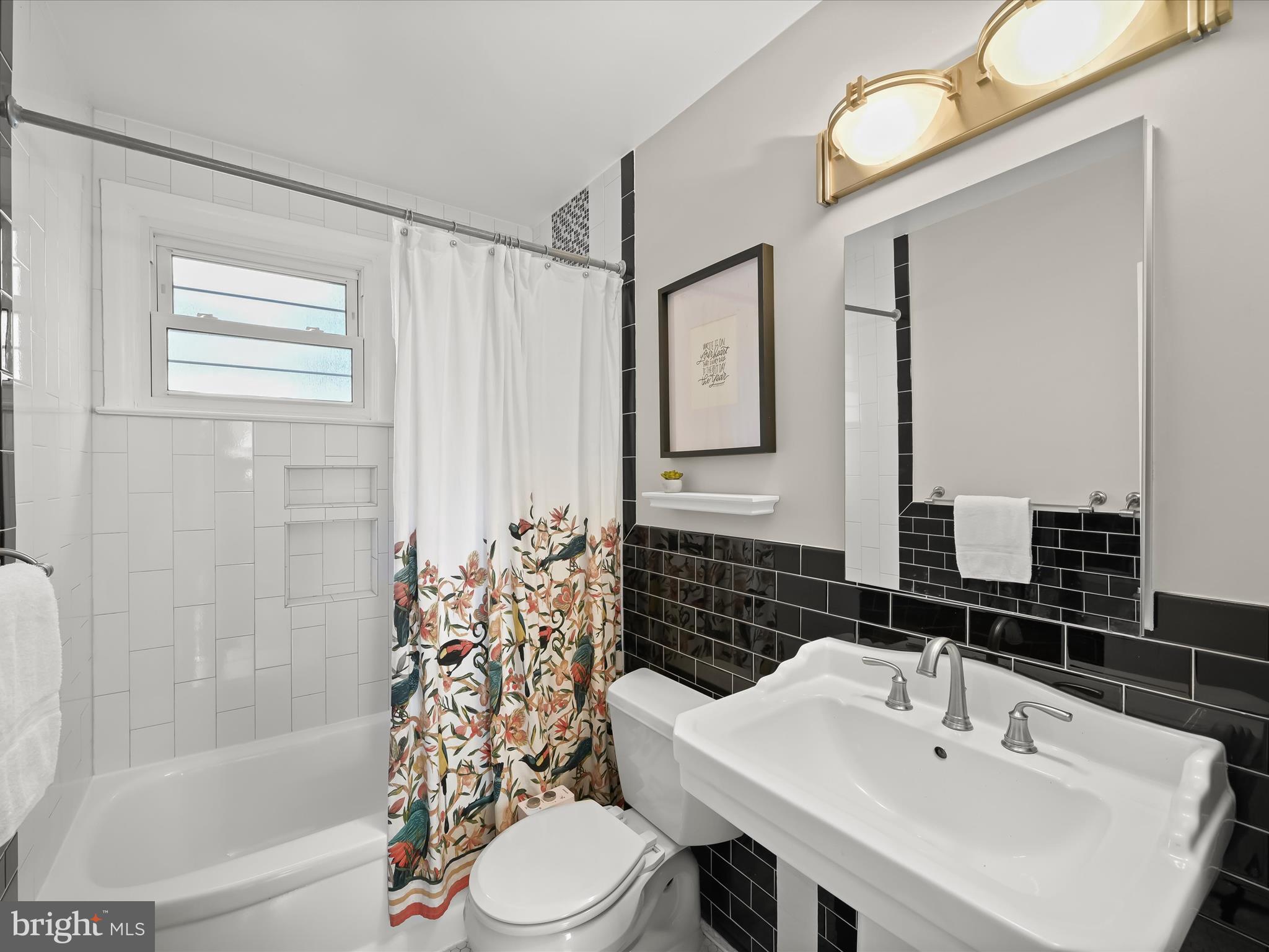 1910 Rollingwood Road Catonsville, MD 21228 - Photo 25 of 40 a bathroom with a sink a toilet and shower