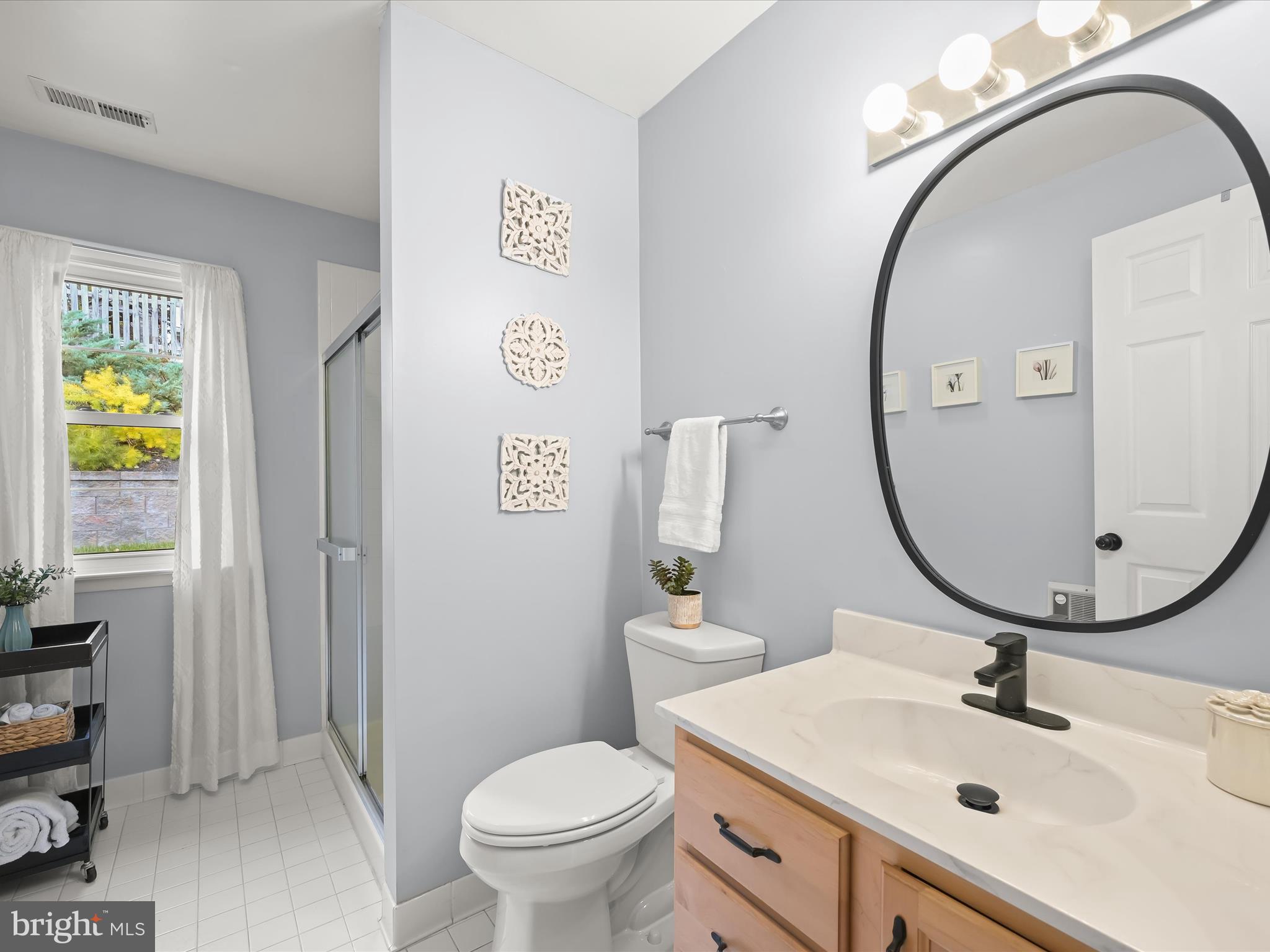 1910 Rollingwood Road Catonsville, MD 21228 - Photo 29 of 40 a bathroom with a sink mirror and toilet