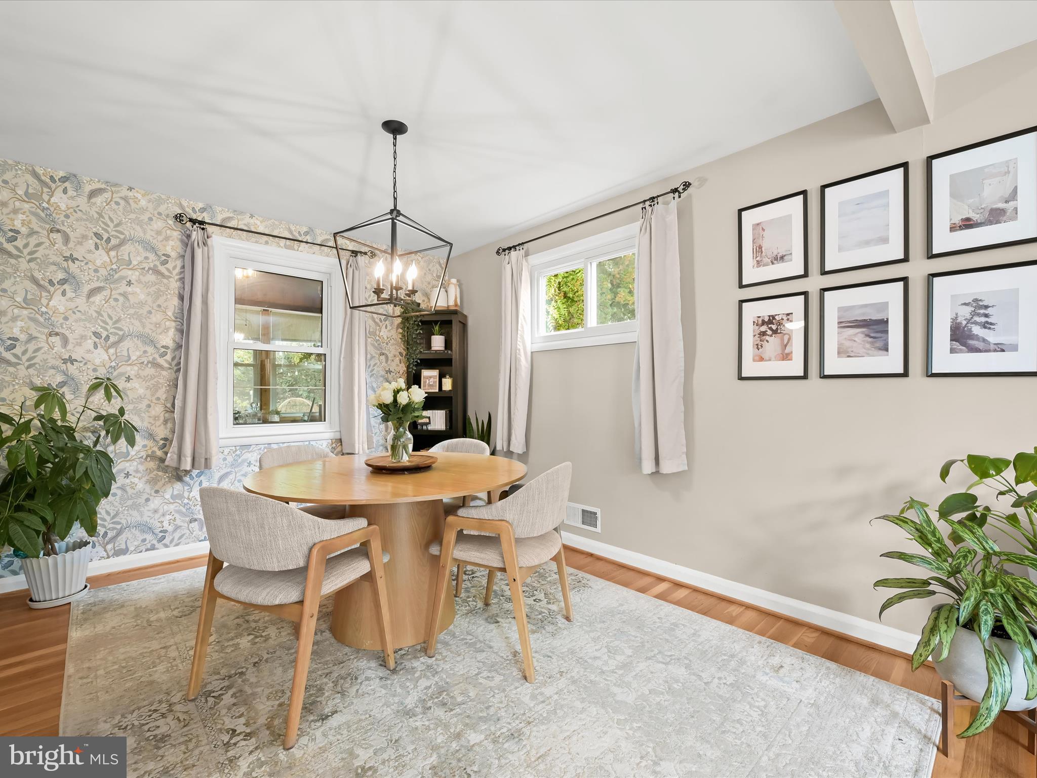 1910 Rollingwood Road Catonsville, MD 21228 - Photo 3 of 40 a dining room with furniture potted plants and wooden floor