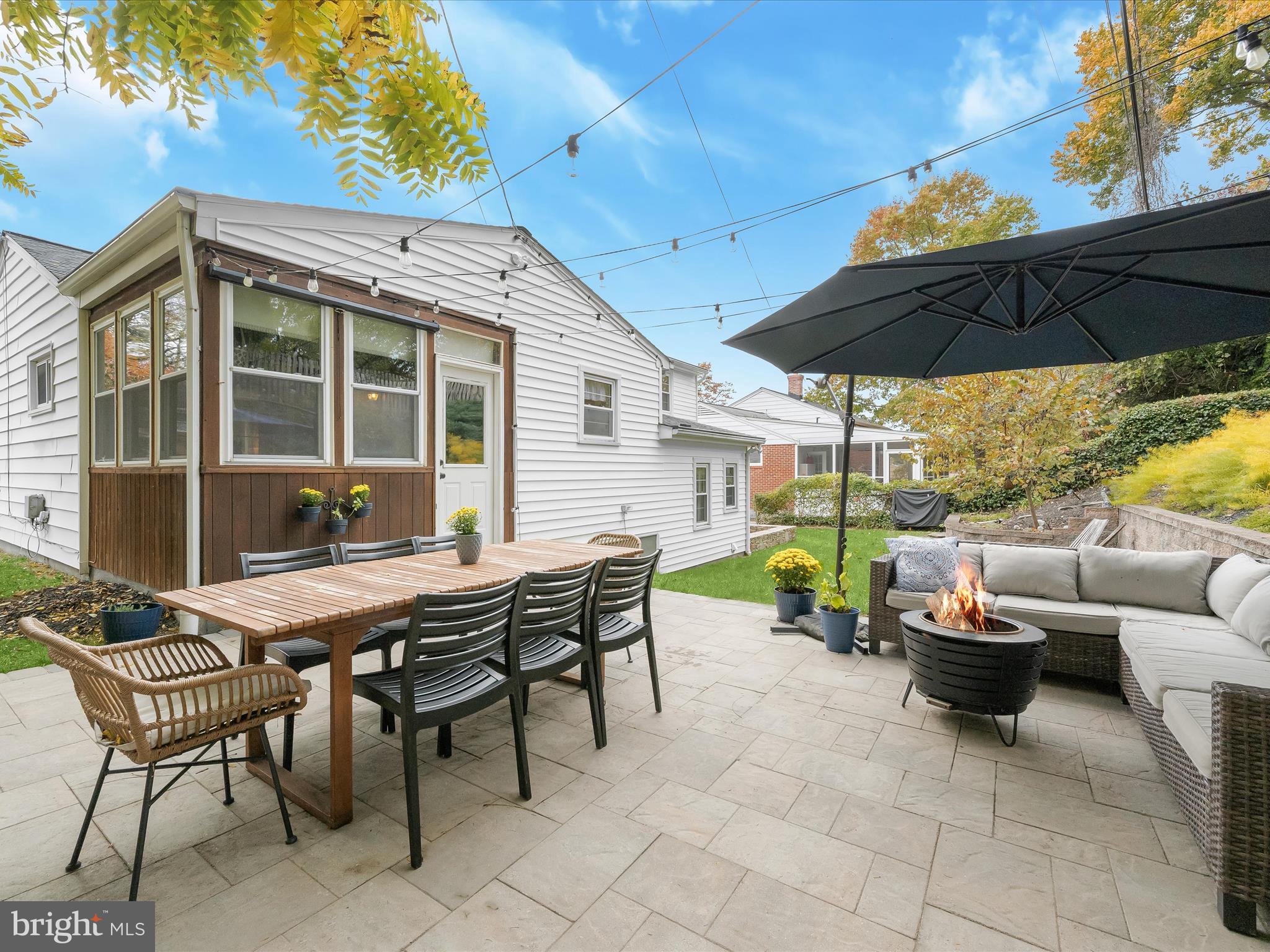 1910 Rollingwood Road Catonsville, MD 21228 - Photo 35 of 40 a view of a patio with a table and chairs under an umbrella