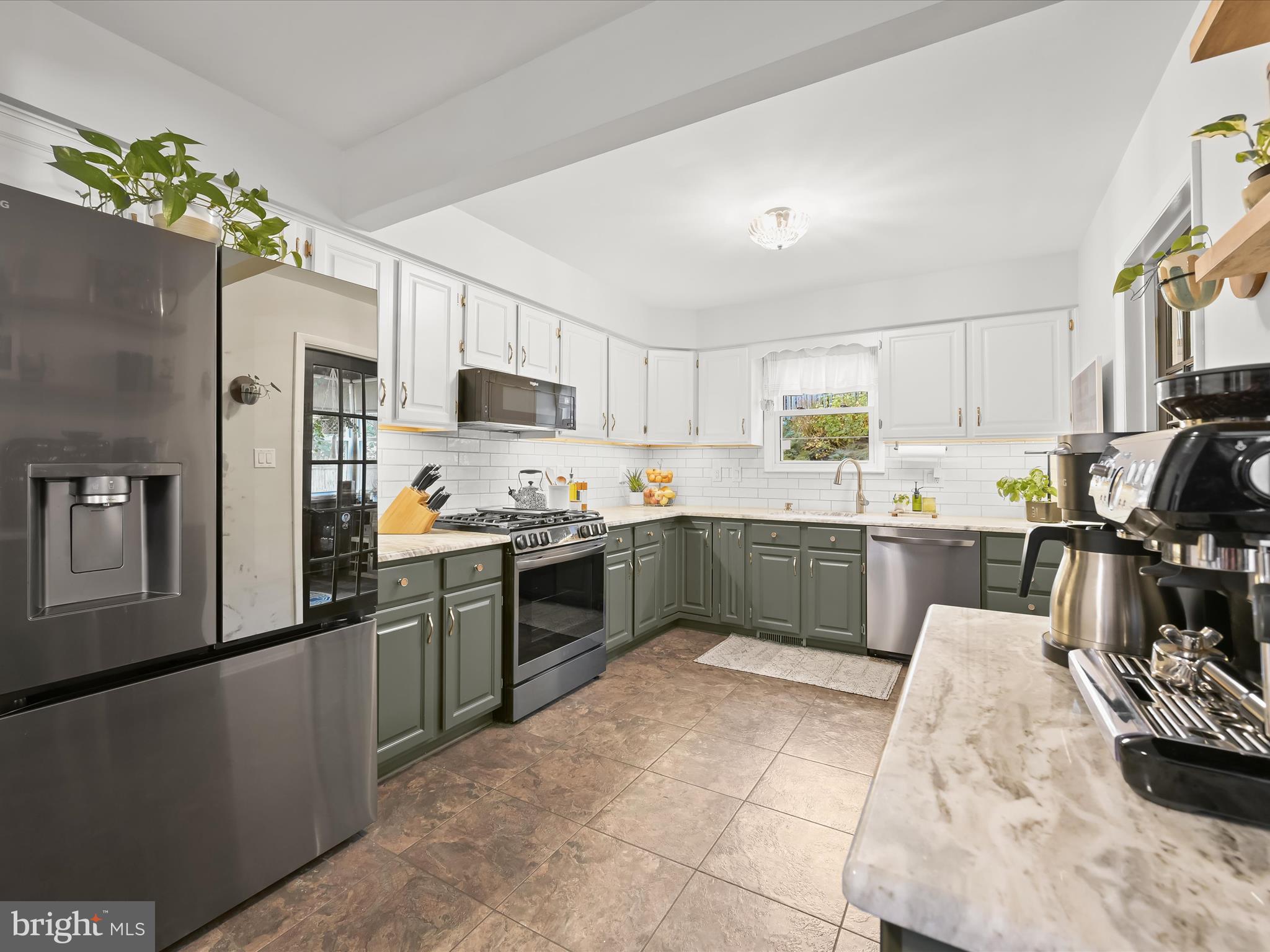 1910 Rollingwood Road Catonsville, MD 21228 - Photo 4 of 40 a kitchen with cabinets and stainless steel appliances