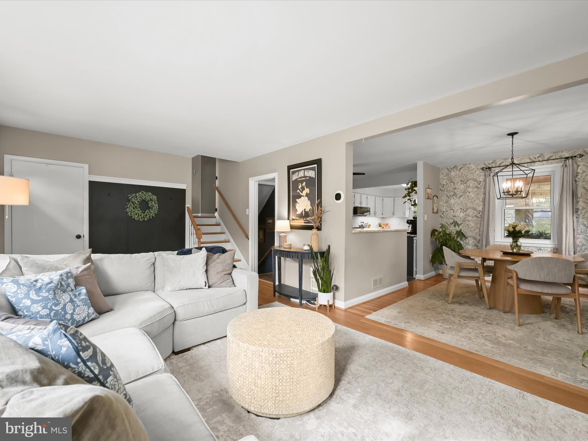 1910 Rollingwood Road Catonsville, MD 21228 - Photo 9 of 40 a living room with furniture and a dining table with wooden floor