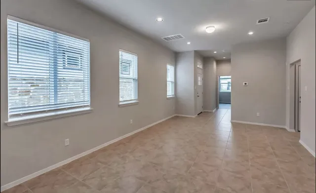 an empty room with windows and closet