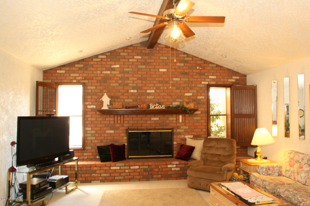 719 North Riata Street Gilbert, AZ 85234 - Photo 4 of 16 Living Room with Brick Fireplace