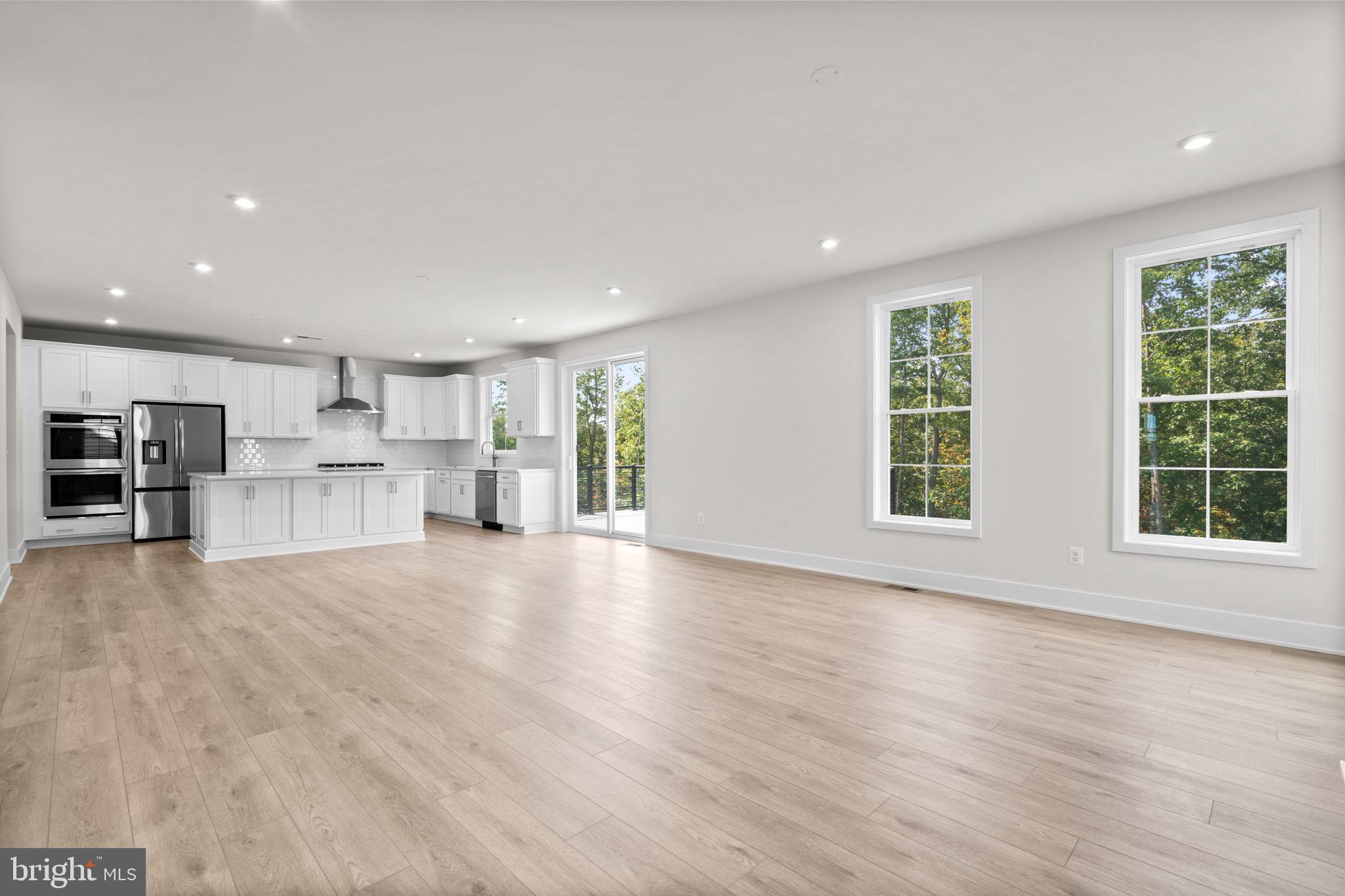 106 Sapphire Street Stephenson, VA 22656 - Photo 16 of 46 a view of kitchen with furniture and wooden floor