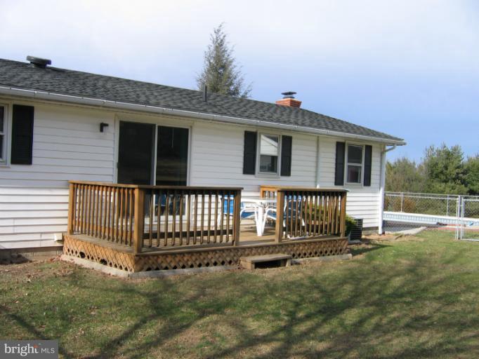 a backyard of a house with a small yard and wooden fence
