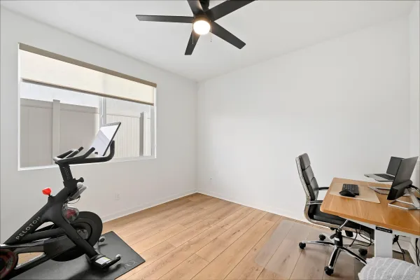 a room with gym equipment and a wooden floor