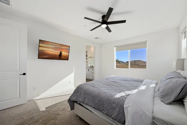 a bedroom with a bed and a painting on the wall