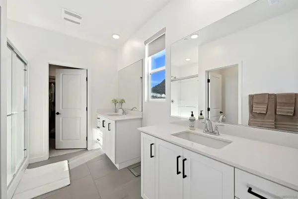 a spacious bathroom with a double vanity sink mirror and