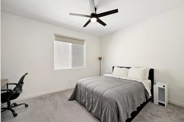 a bedroom with a bed and a window