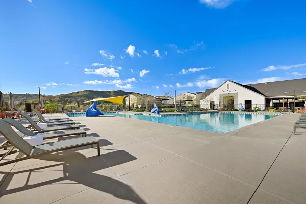 a view of swimming pool with outdoor seating and a patio