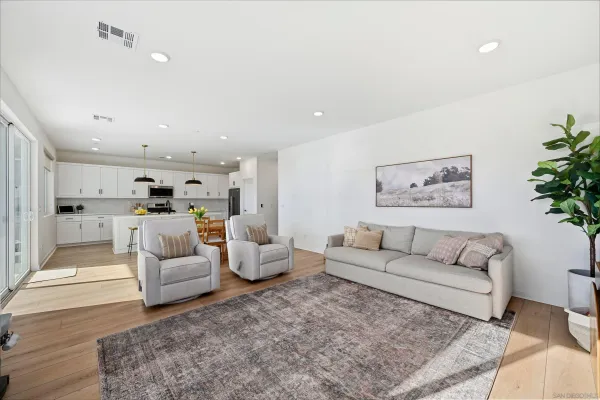 a living room with furniture white walls and white walls