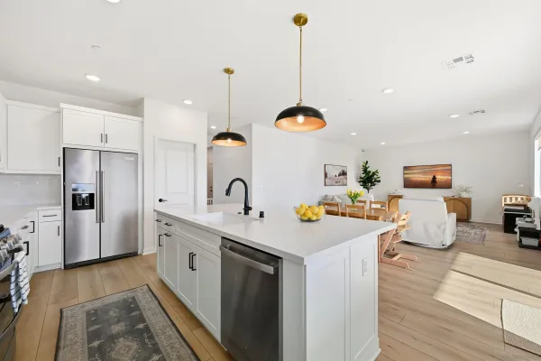 a kitchen with a sink a stove and chairs