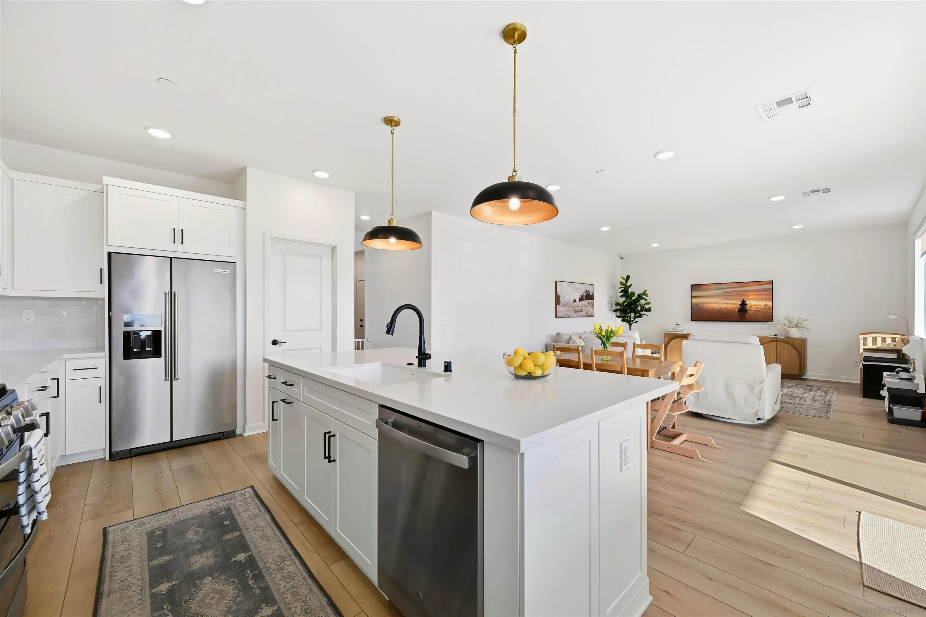 35158 Orchard Trail Fallbrook, CA 92028 - Photo 9 of 40 a kitchen with a sink a stove and chairs