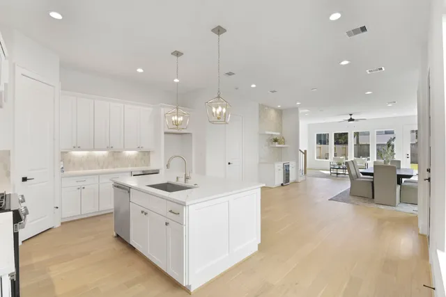 a kitchen with a sink stove and cabinets