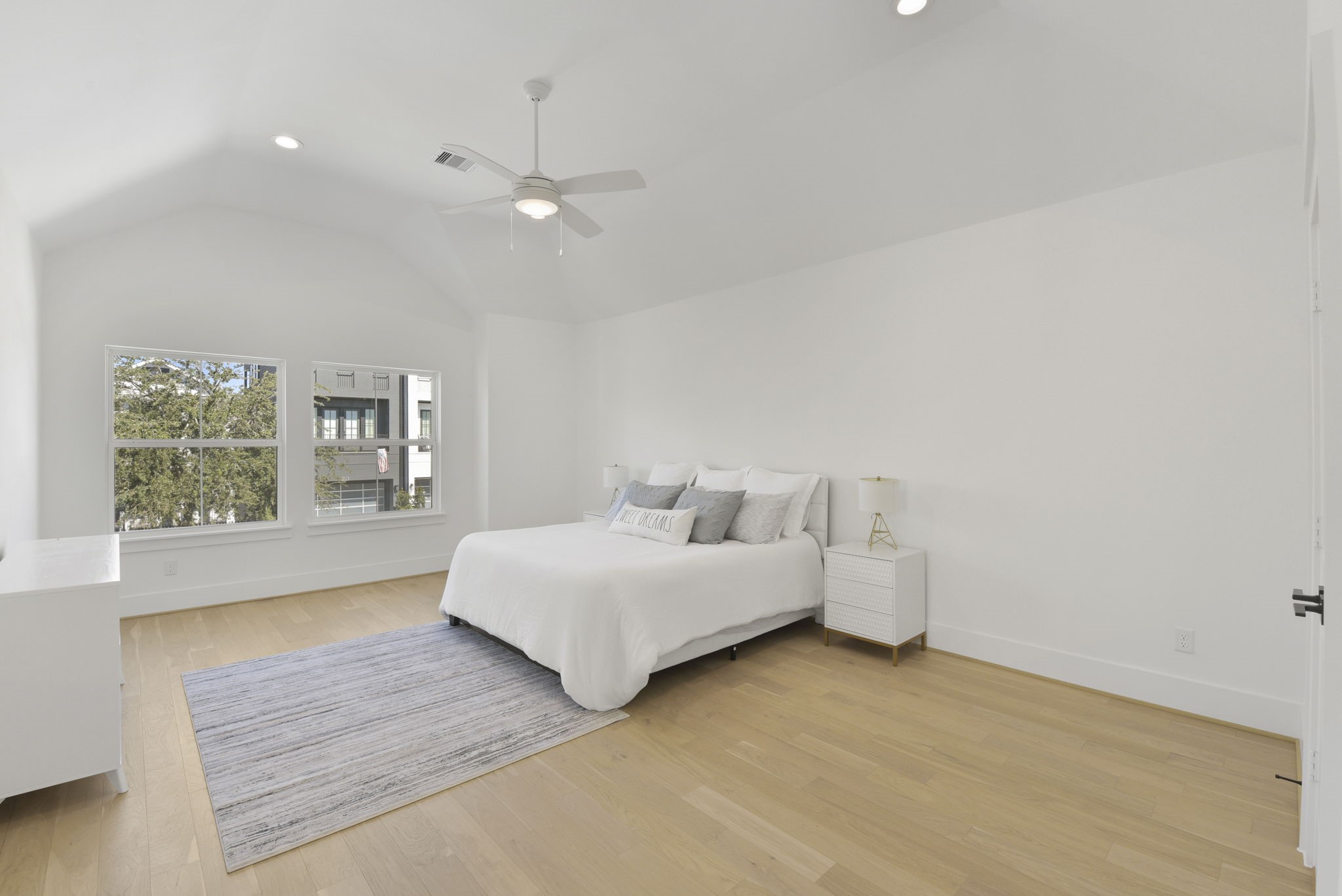 2916 Virginia Street Houston, TX 77098 - Photo 9 of 19 a spacious bedroom with a bed and a large window