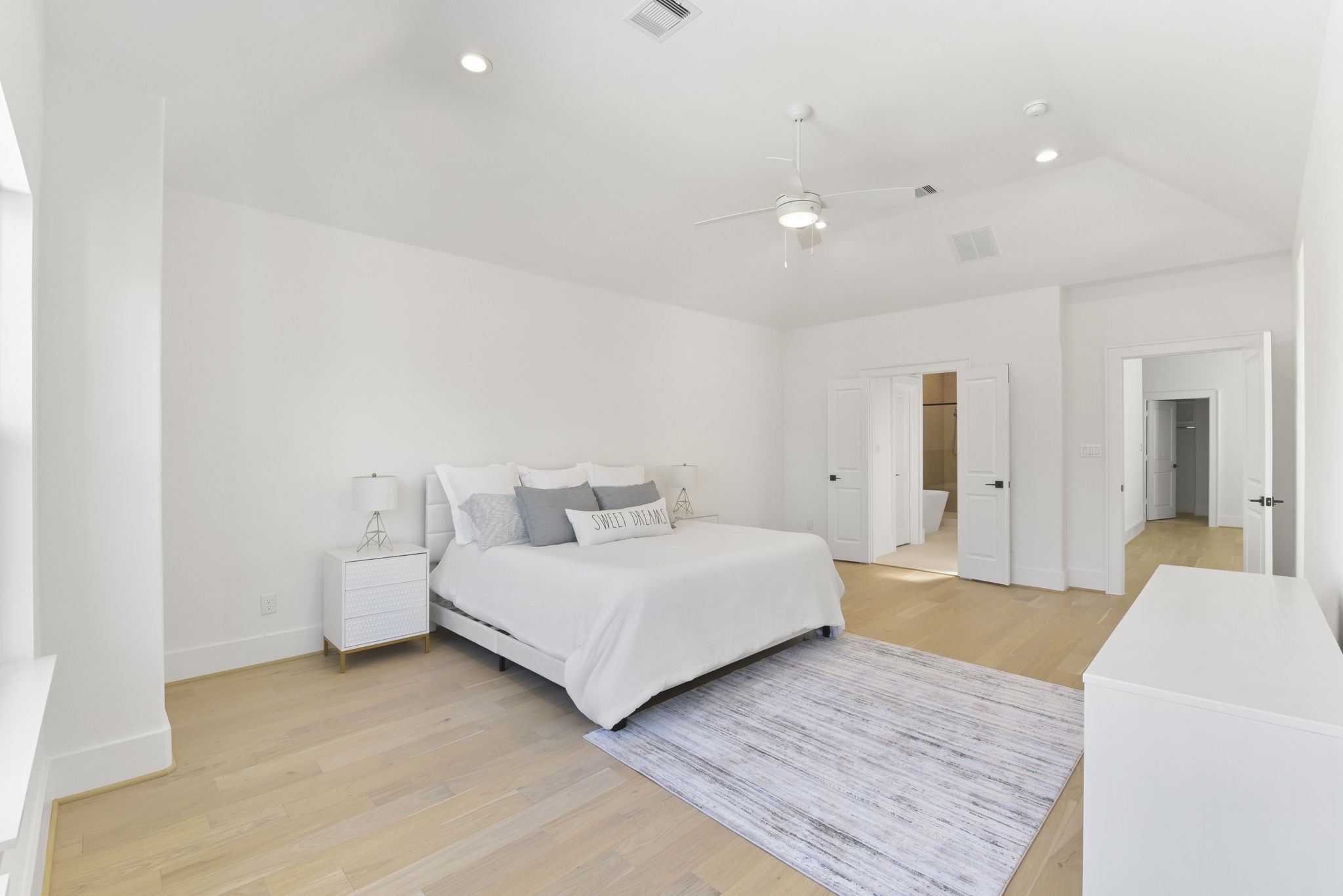 2916 Virginia Street Houston, TX 77098 - Photo 10 of 19 a spacious bedroom with a bed and a couch