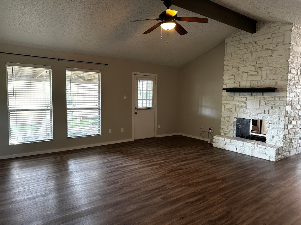 504 Suzzane Road Pflugerville, TX 78660 - Photo 5 of 15 a view of empty room with wooden floor and fireplace