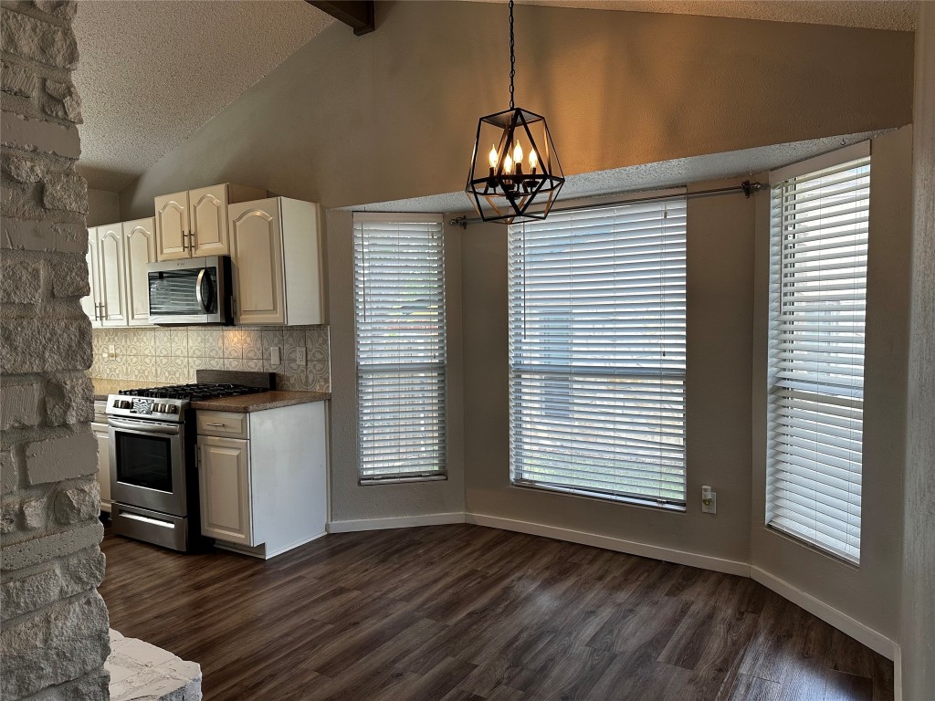 504 Suzzane Road Pflugerville, TX 78660 - Photo 8 of 15 a kitchen with stainless steel appliances granite countertop a sink and a stove