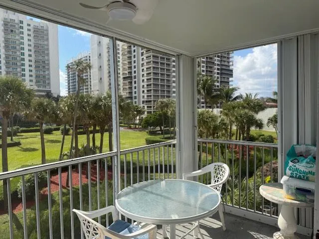 a view of a balcony with chair and wooden floor