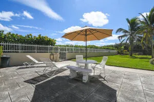 a view of a tables and chairs under an umbrella