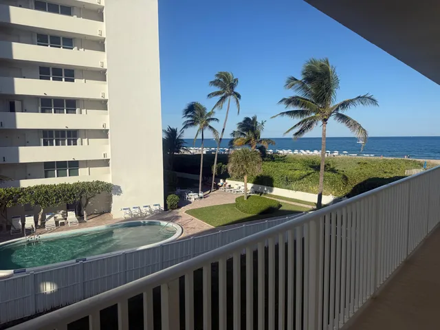 a view of a chairs and table in the balcony