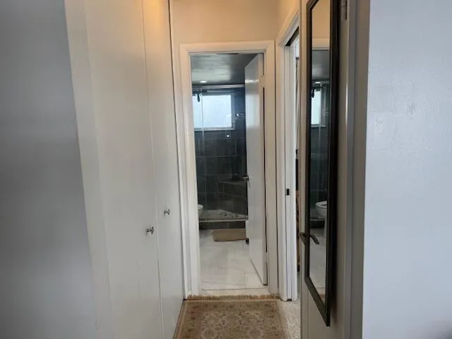 wooden floor with a bathroom