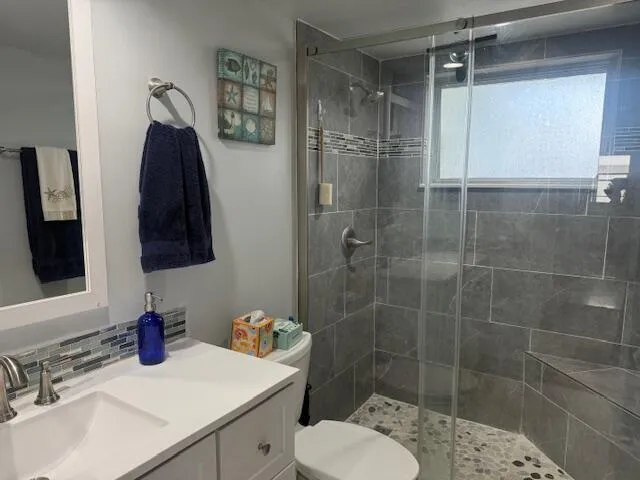 a bathroom with a sink toilet and shower