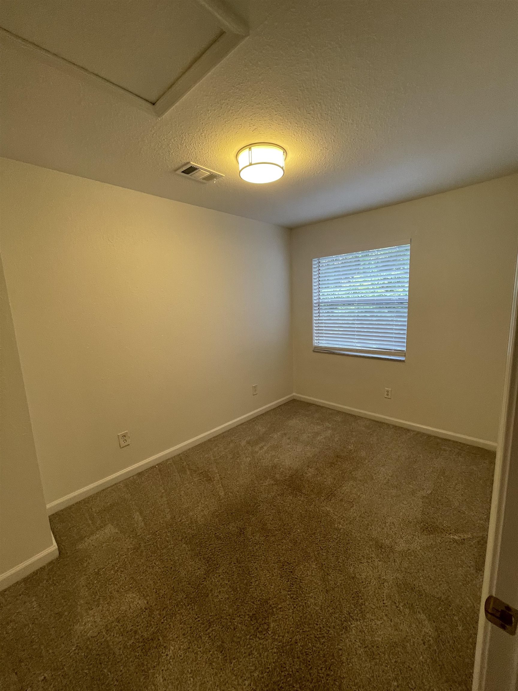 4420 Carter Road, Unit 60 St. Augustine, FL 32086 - Photo 13 of 14 an empty room with a empty space and windows