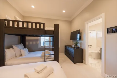 a bedroom with furniture and a flat screen tv